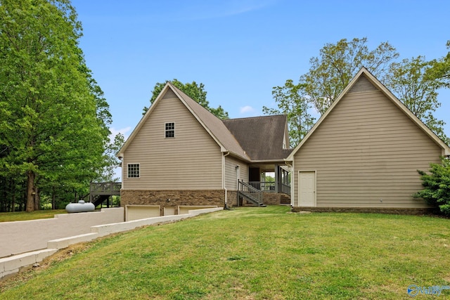 view of property featuring a garage and a front lawn