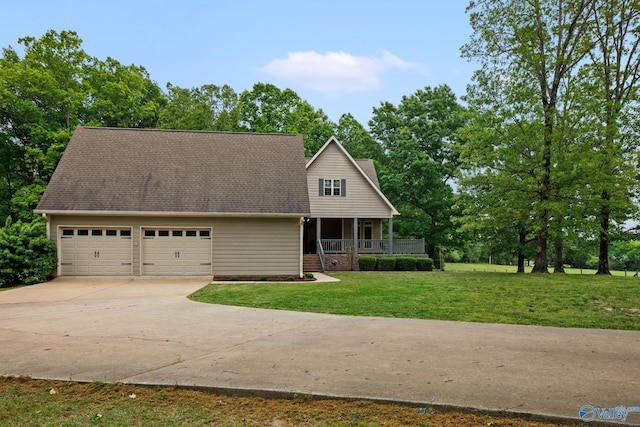 view of front facade with a garage, a front lawn, and covered porch