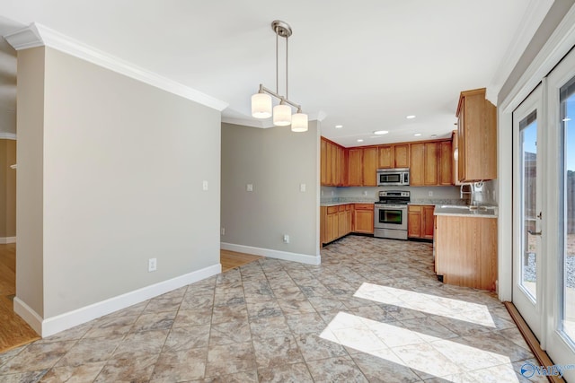 kitchen featuring baseboards, plenty of natural light, ornamental molding, stainless steel appliances, and light countertops