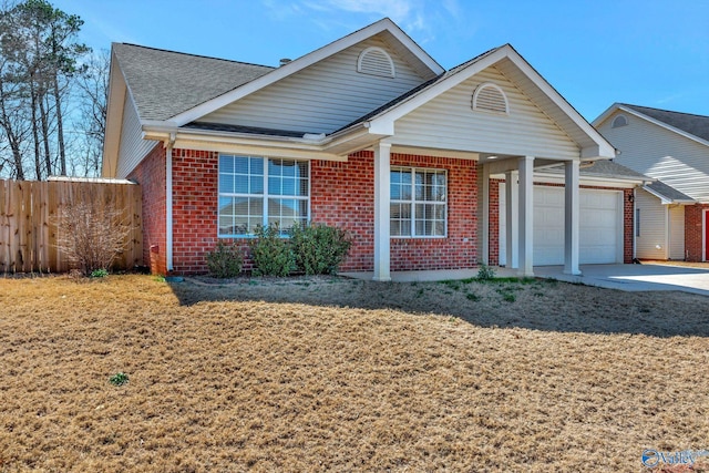 view of front of home with brick siding, fence, concrete driveway, roof with shingles, and a garage