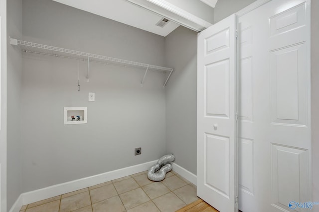 washroom with washer hookup, light tile patterned floors, baseboards, hookup for an electric dryer, and laundry area