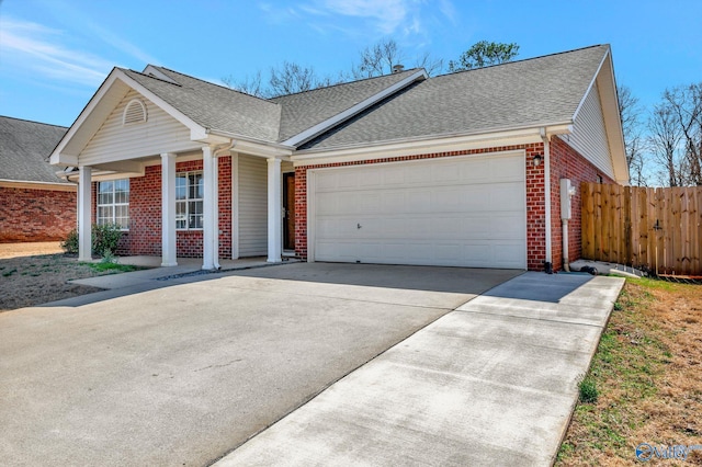 view of front of home with brick siding, fence, concrete driveway, roof with shingles, and a garage