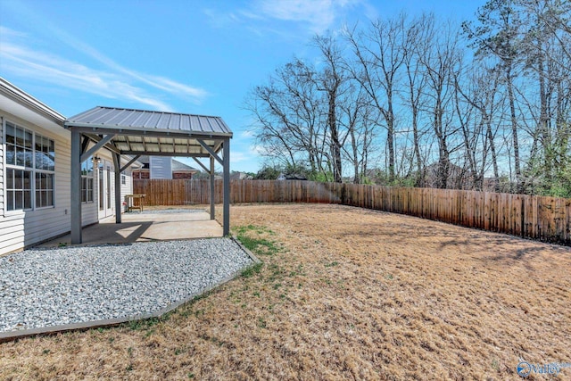 view of yard with a gazebo, a fenced backyard, and a patio area