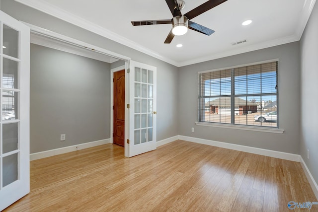 unfurnished room featuring light wood-type flooring, visible vents, ornamental molding, french doors, and baseboards