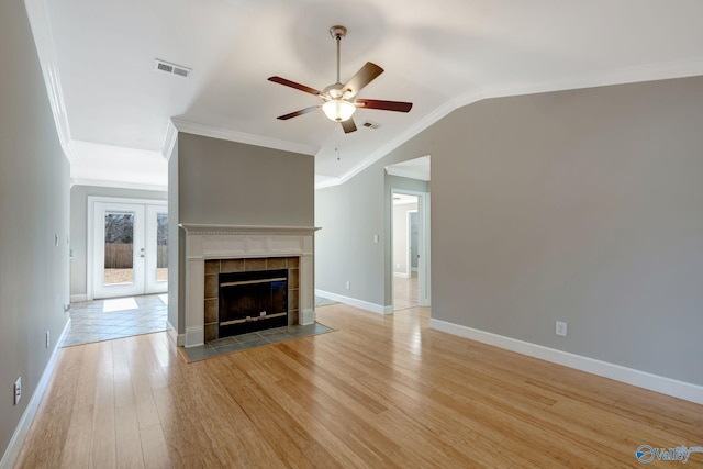 unfurnished living room with visible vents, crown molding, ceiling fan, vaulted ceiling, and light wood-style flooring