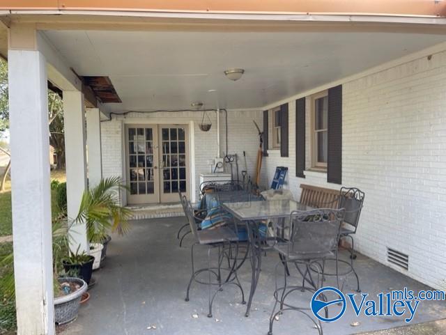 view of patio / terrace with french doors, outdoor dining area, and visible vents