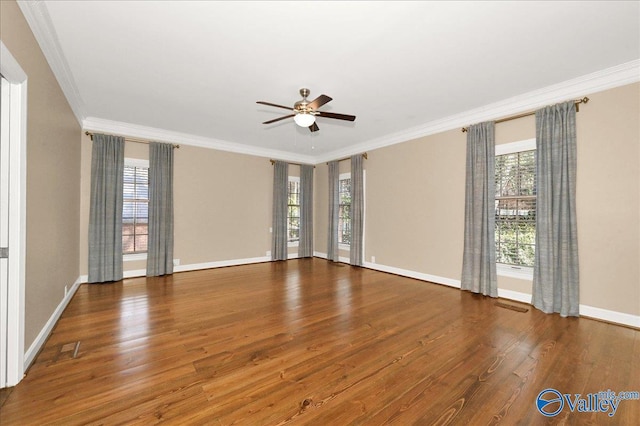 unfurnished room with ornamental molding, a healthy amount of sunlight, dark wood finished floors, and a ceiling fan