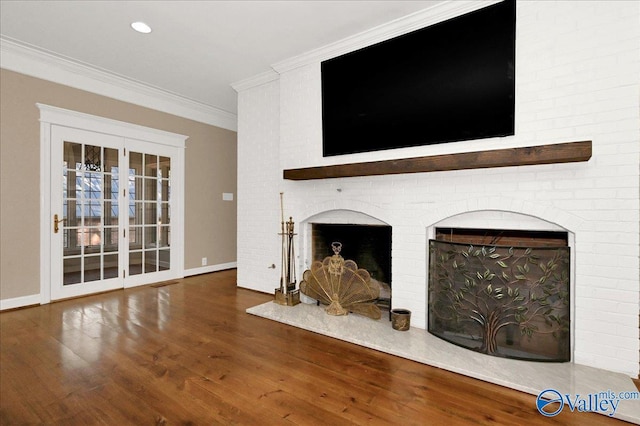 unfurnished living room featuring baseboards, dark wood-style floors, crown molding, a fireplace, and recessed lighting