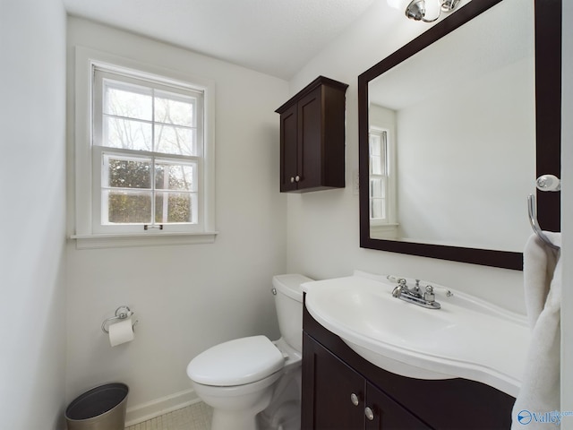 bathroom with tile patterned floors, vanity, and toilet