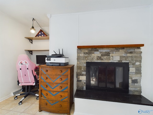 interior space with a stone fireplace, tile patterned flooring, and ornamental molding