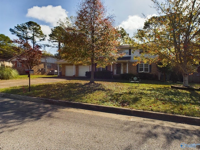 view of property hidden behind natural elements with a front yard