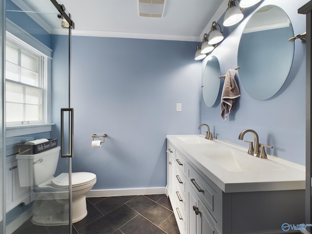 bathroom with toilet, vanity, tile patterned floors, and crown molding