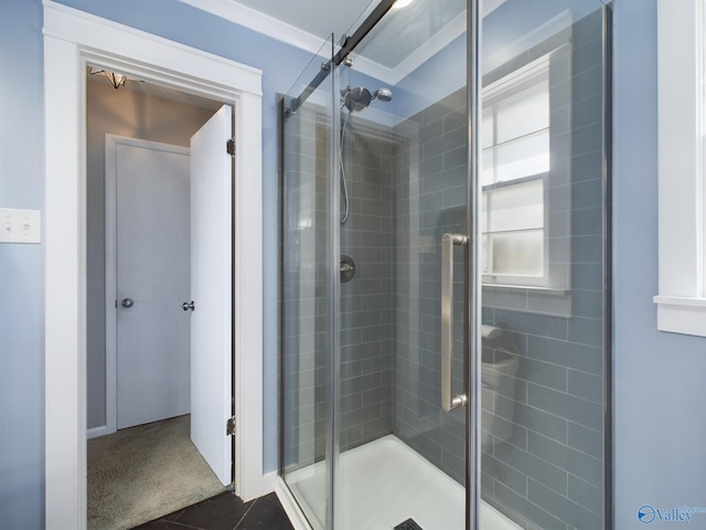 bathroom with tile patterned flooring and a shower with shower door