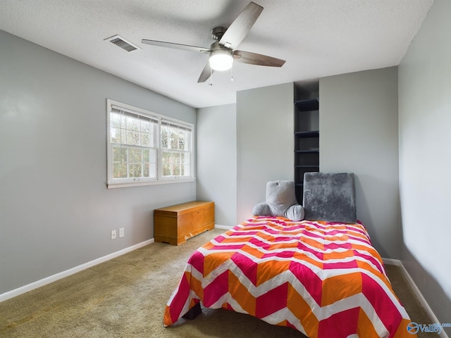 bedroom featuring carpet, a textured ceiling, and ceiling fan