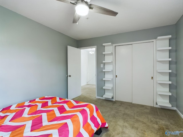 carpeted bedroom featuring ceiling fan and a closet