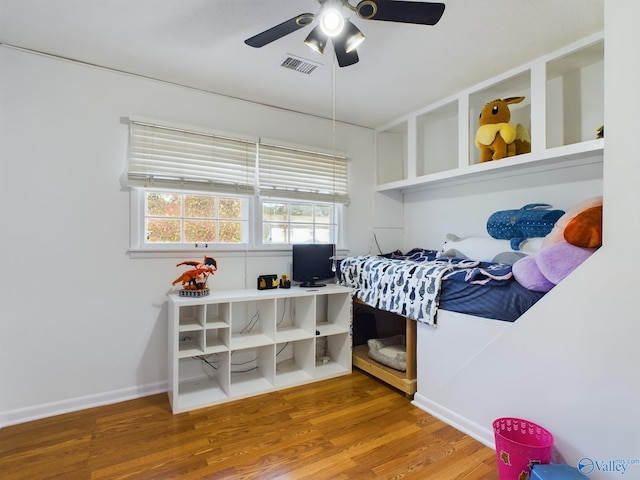 bedroom with hardwood / wood-style floors and ceiling fan