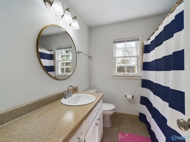 bathroom featuring walk in shower, tile patterned flooring, vanity, and toilet