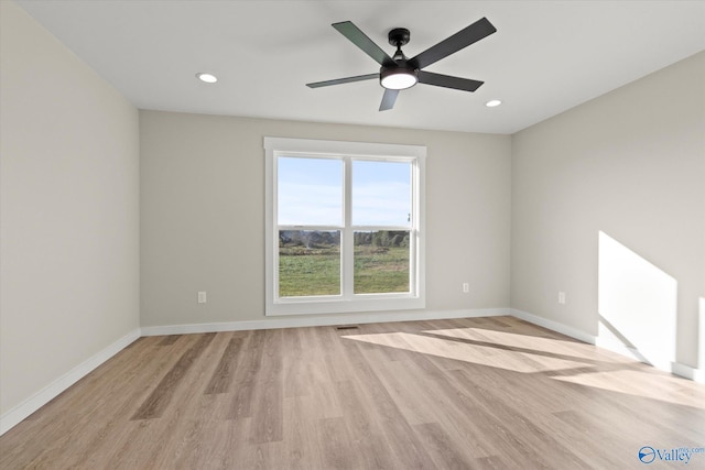 empty room featuring light wood-type flooring and ceiling fan