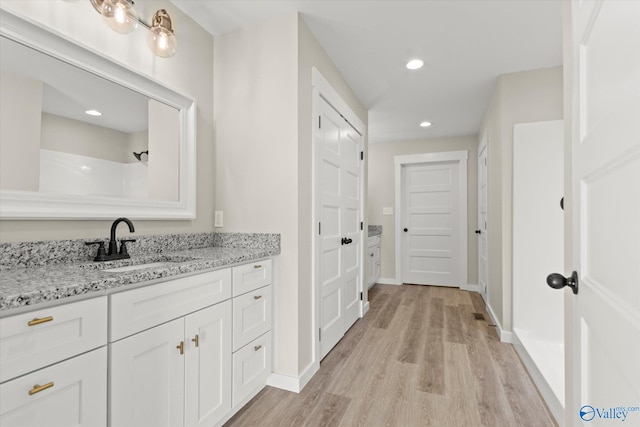 bathroom with vanity and wood-type flooring