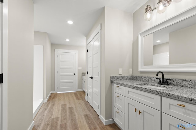 bathroom featuring vanity and wood-type flooring