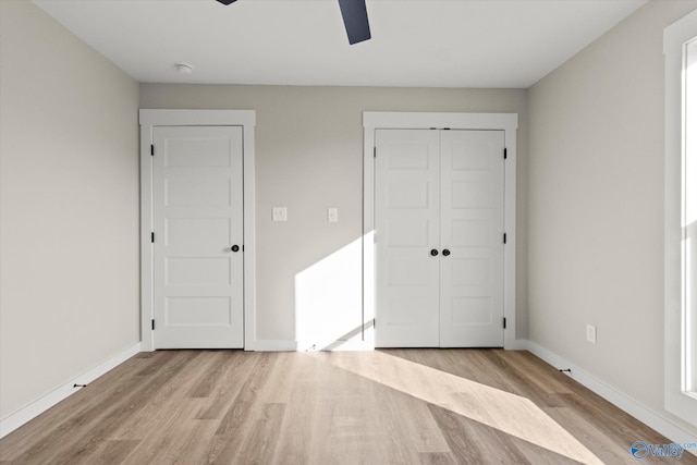 unfurnished bedroom featuring a closet, light wood-type flooring, and ceiling fan