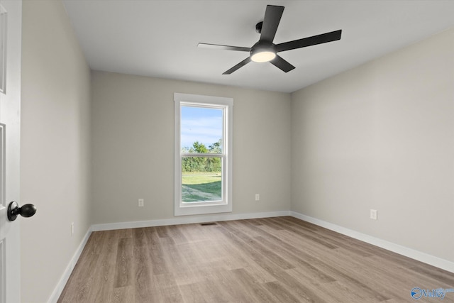 spare room featuring light hardwood / wood-style floors and ceiling fan