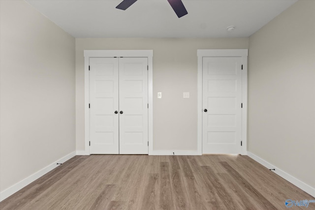 unfurnished bedroom with a closet, light hardwood / wood-style floors, and ceiling fan