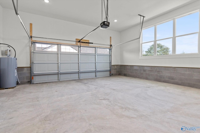 garage featuring a garage door opener and electric water heater