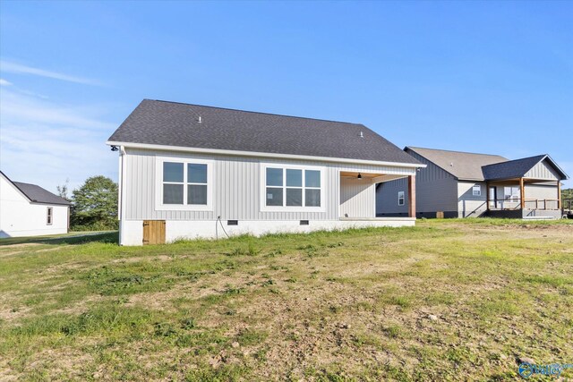 rear view of house featuring a lawn