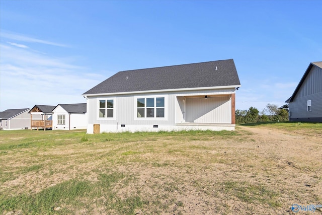 rear view of house featuring a yard