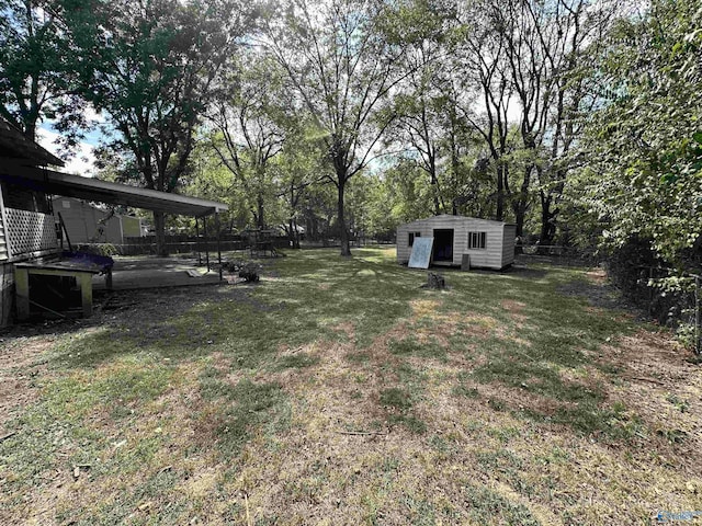 view of yard featuring an outdoor structure and a patio