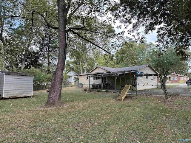 view of yard with an outbuilding and a shed