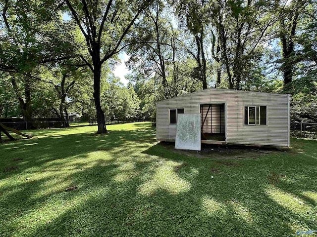 view of outdoor structure featuring an outbuilding and fence