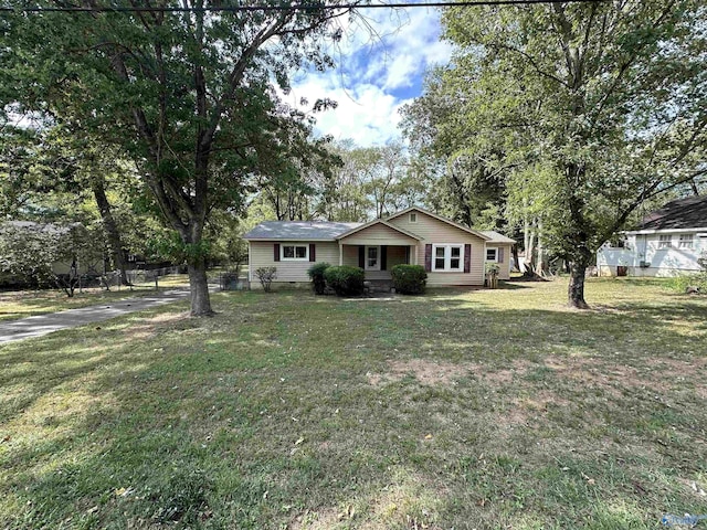 view of front of home with crawl space, fence, and a front lawn