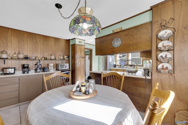 tiled dining space with wood walls