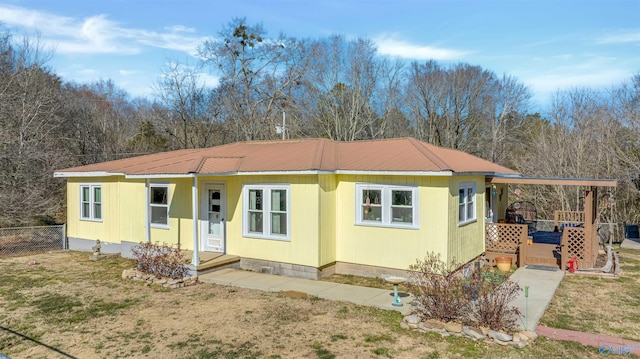 manufactured / mobile home featuring a deck and a front lawn