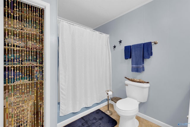 bathroom featuring toilet, shower / bath combo, and tile patterned flooring