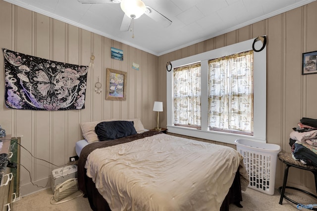 bedroom with ceiling fan, crown molding, and light carpet