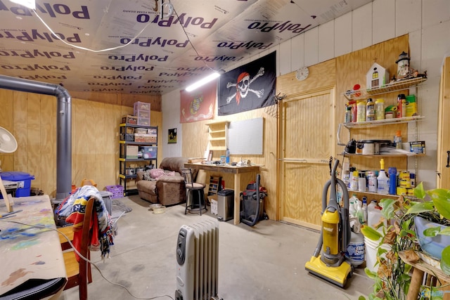 basement featuring wooden walls