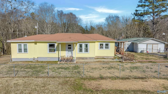 view of front of property featuring a garage, a front yard, a carport, and an outdoor structure