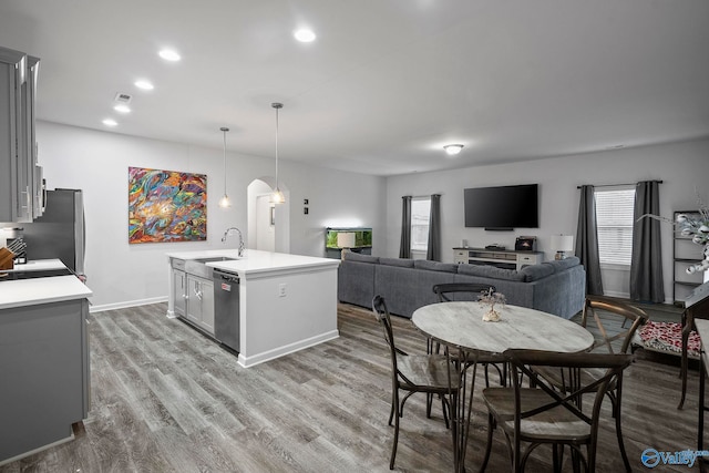 kitchen featuring a healthy amount of sunlight, appliances with stainless steel finishes, a sink, and gray cabinetry