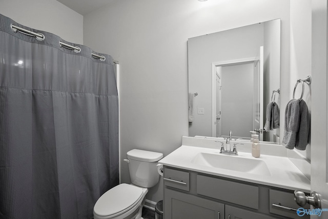 full bathroom with toilet, vanity, and a shower with shower curtain