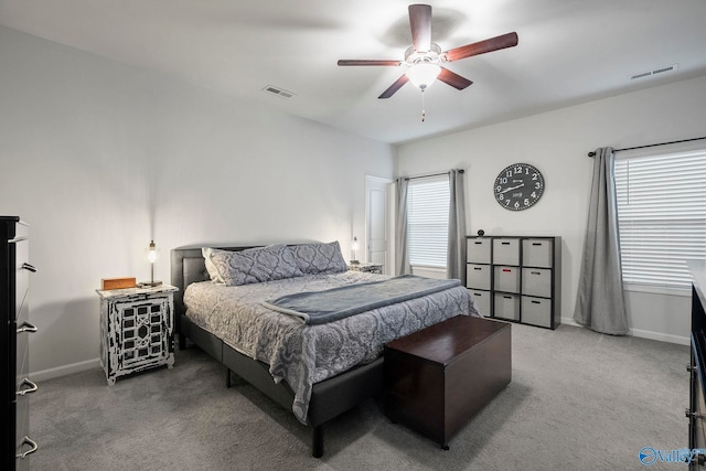 carpeted bedroom with ceiling fan, baseboards, and visible vents