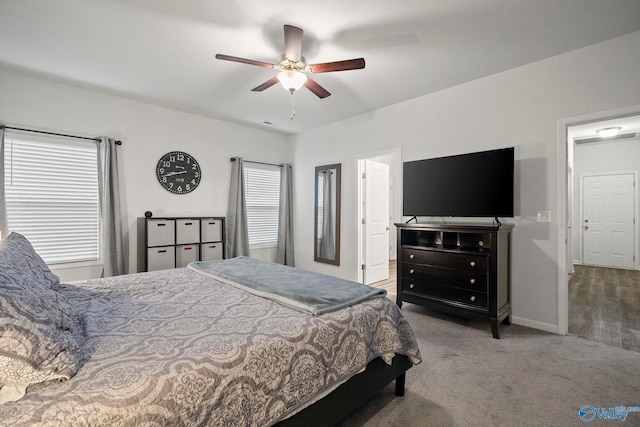 carpeted bedroom featuring baseboards and ceiling fan
