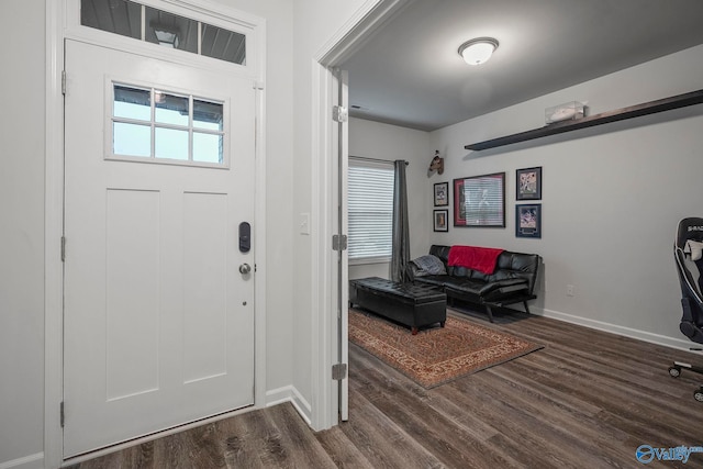 foyer featuring baseboards and dark wood-style flooring