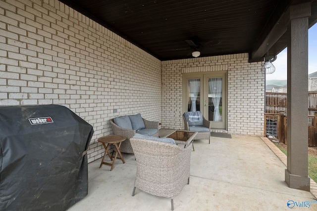 view of patio featuring a ceiling fan, outdoor lounge area, a grill, fence, and french doors