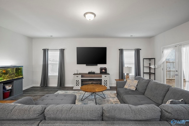 living room with baseboards and wood finished floors