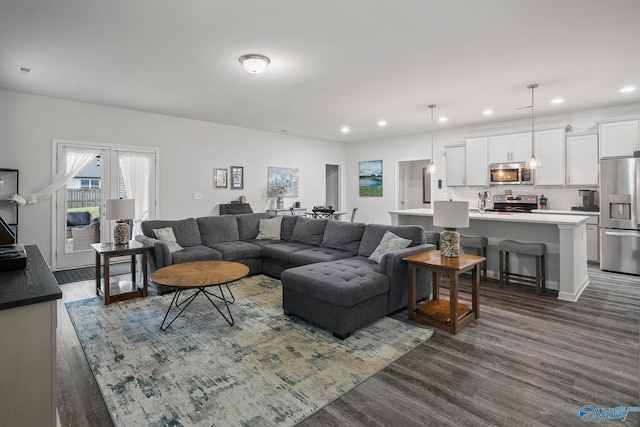 living area featuring dark wood finished floors and recessed lighting