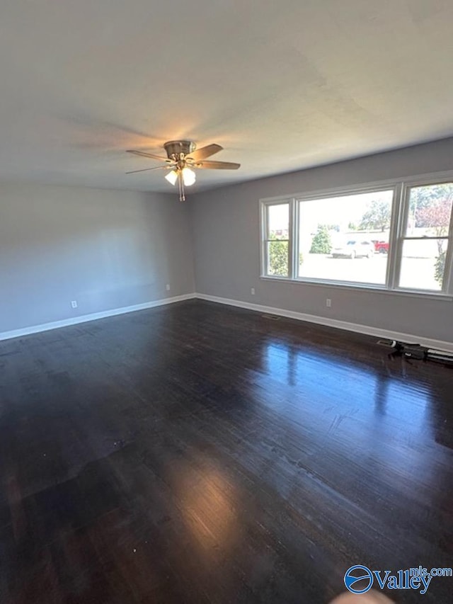 unfurnished room featuring ceiling fan and dark hardwood / wood-style floors