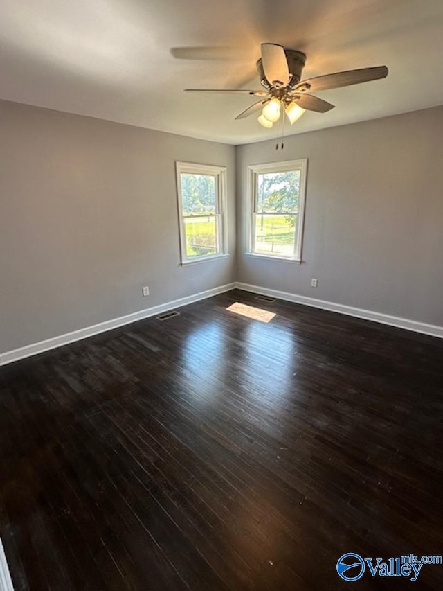 empty room featuring ceiling fan and dark hardwood / wood-style floors